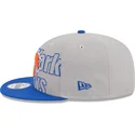graue-und-blaue-flatcap-snapback-9fifty-draft-edition-2023-der-new-york-knicks-nba-von-new-era