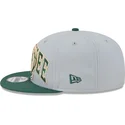 graue-und-grune-snapback-kappe-9fifty-tip-off-2023-der-milwaukee-bucks-nba-von-new-era